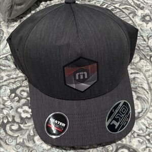 Travis Matthew’s Black urban heater Flexfit 110 Cap